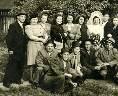  1945 post war backyard wedding. No family just a few fellow survivors. My parents are on the left 